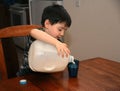 Three Year Old Pouring Milk Royalty Free Stock Photo