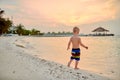 Three year old toddler boy on beach at sunset Royalty Free Stock Photo