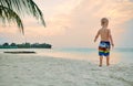 Three year old toddler boy on beach at sunset Royalty Free Stock Photo