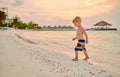 Three year old toddler boy on beach at sunset Royalty Free Stock Photo