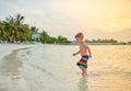 Three year old toddler boy on beach at sunset Royalty Free Stock Photo