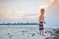 Three year old toddler boy on beach at sunset Royalty Free Stock Photo