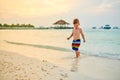 Three year old toddler boy on beach at sunset Royalty Free Stock Photo