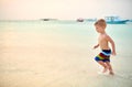 Three year old toddler boy on beach at sunset Royalty Free Stock Photo