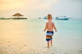 Three year old toddler boy on beach at sunset Royalty Free Stock Photo