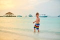 Three year old toddler boy on beach at sunset Royalty Free Stock Photo