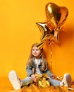 Three years girl toddler kid with gold presents balloons and birthday cap celebrating Royalty Free Stock Photo