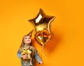 Three years girl toddler kid with gold presents balloons and birthday cap celebrating Royalty Free Stock Photo