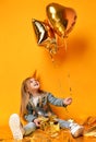 Three years girl toddler kid with gold presents balloons and birthday cap celebrating Royalty Free Stock Photo