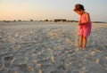 Three years old girl playing with sand