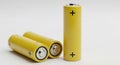 Three Yellow A Batteries with Plus Signs on a White Background battery power Royalty Free Stock Photo