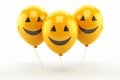 Three yellow balloons with a smiley face on white background Royalty Free Stock Photo