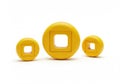 Three yellow circular objects with square openings, isolated on white background Royalty Free Stock Photo