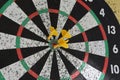 Three Yellow Darts Targetted in the Center of a Dartboard Royalty Free Stock Photo