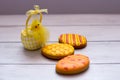 Three yellow easter cookies with a chik on the left