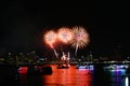 three yellow orange fireworks on beach and reflection color on water surface Royalty Free Stock Photo