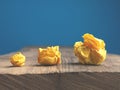 Three yellow paper balls on a table