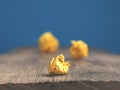 Three yellow paper balls on a table