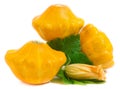 Three yellow pattypan squash with leaf and flower isolated on white background Royalty Free Stock Photo