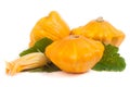 Three yellow pattypan squash with leaf and flower isolated on white background