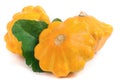 Three yellow pattypan squash with leaf isolated on white background Royalty Free Stock Photo