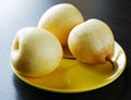 Three yellow pears on the plate Royalty Free Stock Photo