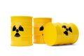 Three yellow radioactive waste drum barrels stack with warning symbol over white background