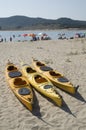 Three yellow sea tandem kayak on beach Royalty Free Stock Photo