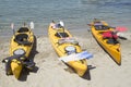 Three yellow sea tandem kayak on beach Royalty Free Stock Photo