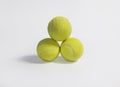 three yellow tennis balls on a white background Royalty Free Stock Photo