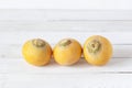 Three yellow turnips on the white wooden background Royalty Free Stock Photo
