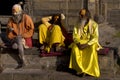 Three yoga in colorful clothes with