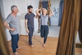 Three yogis standing barefoot during the workout