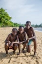 Three young African boys posing for a photo at beach near Kribi water falls, Cameroon, Central Africa