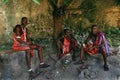 Three young Africans, Masai clothing, rest in the shade. Royalty Free Stock Photo