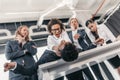 Three young angry businesswomen punishing businessman lying on table Royalty Free Stock Photo