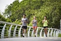 three young asian people running jogging outdoors Royalty Free Stock Photo