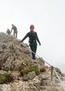 Three young attractive female and male mountain climbers in the Dolomites of italy