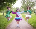 Three young beautiful girls in irish dance dress posing outdoor