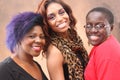 Three young black women together smiling