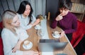 Three young business women sitting at table with laptop and working on a project in cafe. Teamwork, business meeting Royalty Free Stock Photo