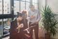 Three young cheerful employees smiling in a modern office Royalty Free Stock Photo