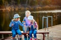 Three young children brag about fish caught on the bait. Concept of friendship and fun weekend or vacation