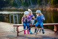 Three young children brag about fish caught on the bait. Concept of friendship and fun weekend or vacation