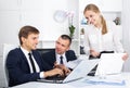 Three young coworkers different sexes working in company office Royalty Free Stock Photo