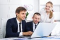 Three young coworkers working in company office Royalty Free Stock Photo