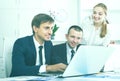 Three young coworkers working in company office Royalty Free Stock Photo