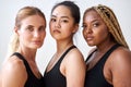 Three young multi ethnic female models of different race, hair colour and body size posing at camera