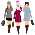 Three young fashion women with shopping bags