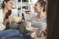 Three young females friends chatting over coffee